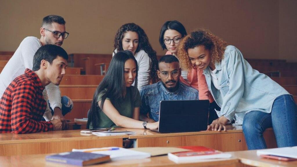 Arden University and Google Cloud Partner on AI Skills: What 30,000 Students and Staff Will Get 1 University students working together on a laptop in a classroom, illustrative stock photo for AI education partnership